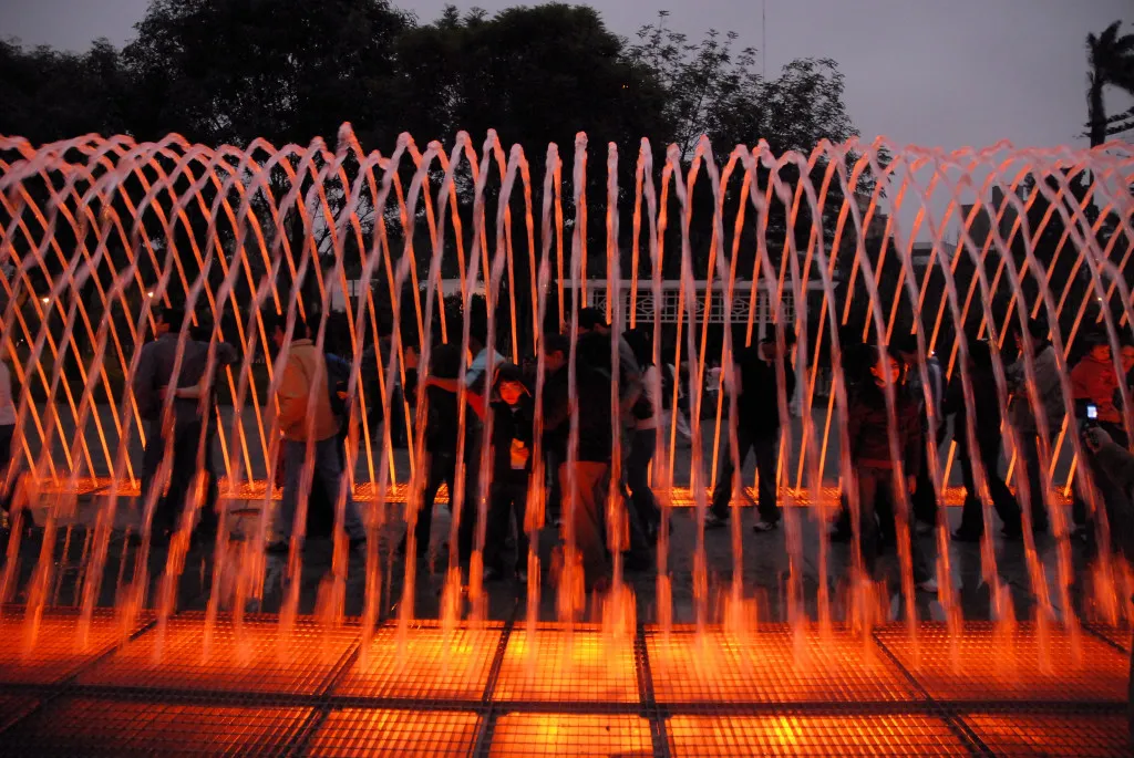 Families walking through the illuminated water tunnel